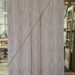 Walnut flush door with bold diagonal line crossing vertical reveals — project 031 by Whitebird Woodcraft