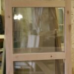 Unfinished knotty Alder door with three tall stacked glass lites in classic vertical arrangement — project 032 by Whitebird Woodcraft