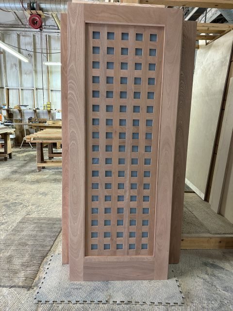 Oak lattice grid glass door with dense small square openings creating intricate pattern — project 033 by Whitebird Woodcraft