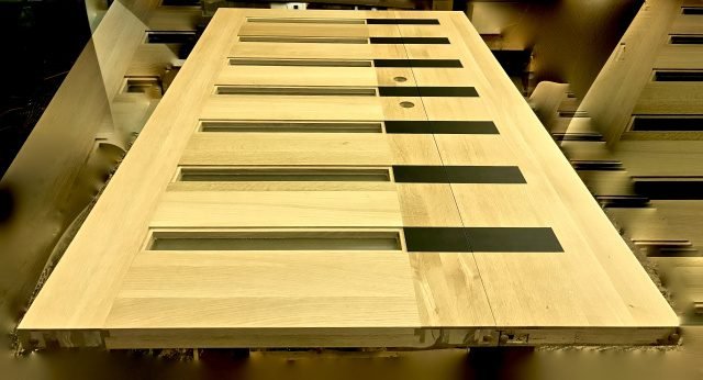 Unfinished oak flush door with six frosted glass slot inserts shown in raw wood — project 034 by Whitebird Woodcraft