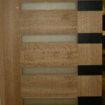 Light wood flush door with six frosted glass slot inserts and black accents — project 027 by Whitebird Woodcraft
