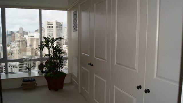 Interior raised panel door package with multiple white doors in built-in wardrobe configuration — project 029 by Whitebird Woodcraft