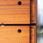 Close-up of the Morpheus Door's stacked wood blocks, showing end grain, drilled holes, and brush seals between each block. Project 035 by Whitebird Woodcraft
