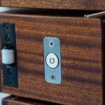 Roller latch and stainless lock plate set flush into a wood block of the Morpheus Door. Project 035 by Whitebird Woodcraft